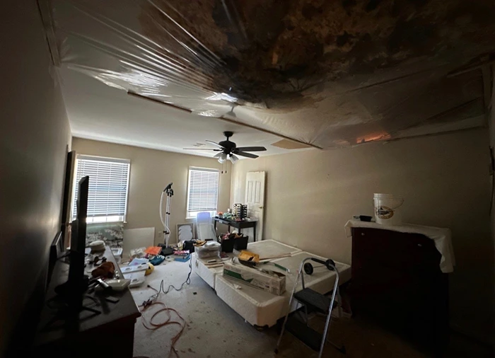 Interior ceiling with heavy water damage and mold from a storm